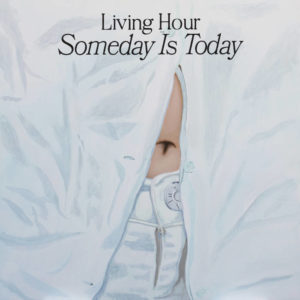 The close up of someone's midsection wearing white jeans and a white button down with the navel visible. Text at the top reads "Living Hour: Someday is Today."