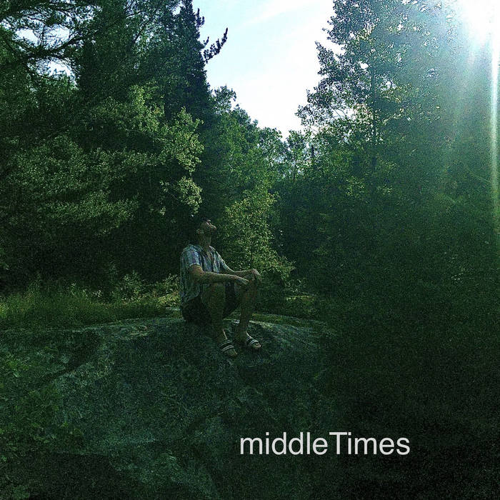 middleTimes EP cover man in sandals shorts and t-shirt sit-in on a rock underneath trees and sun flare in upper right corner.