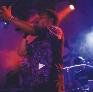 Cadence Weapon performing on stage.