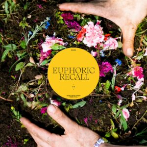 Two hands in dirt with bright, mostly pink coloured flowers. In the center there is a yellow circle with black text that reads "Euphoric Recall".