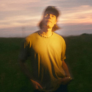 Kris Ulrich in a field at sunset.