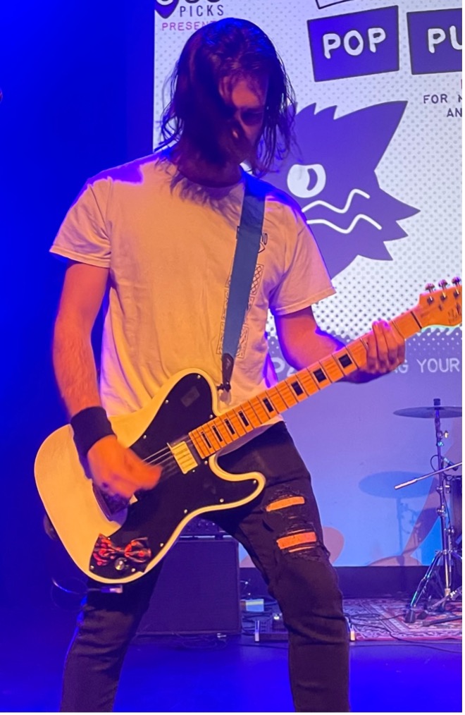 Guitar player performing at Pop Punk Party at the Park Theatre.