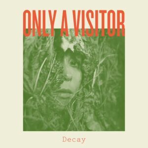 A persons face peeking out from below moss and leaves. Image has an off-white border with orange text at the top reading "Only a Visitor" and at the bottom reads "Decay."