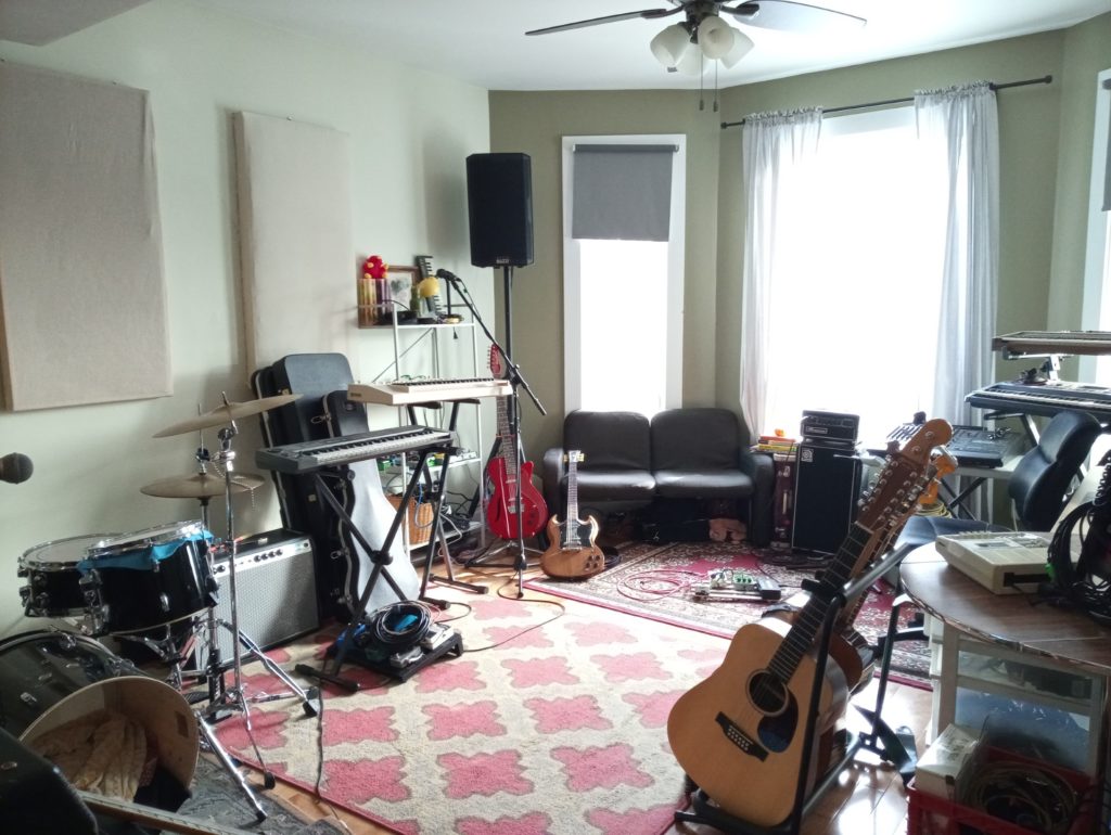 The jam space. Instruments everywhere, cute carpet and sound pannels on the wall with gauzy curtains
