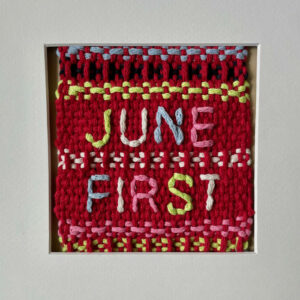 Thread art with multicoloured text, the first line reads "JUNE" and the second line reads "FIRST." The background is red with multicoloured details, including blue, black, yellow, white, pink, and green.